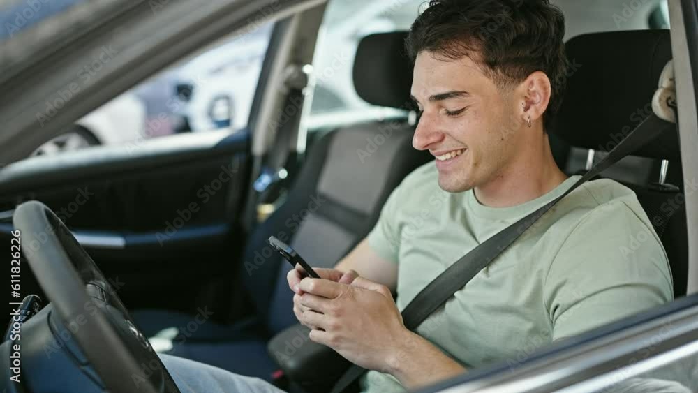 Young hispanic man using smartphone sitting on car at street Young hispanic man using smartphone sitting on car at street