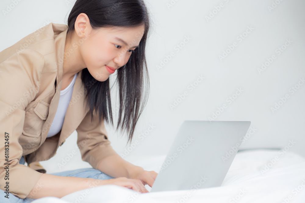Beautiful young asian woman sitting on bed using laptop computer working from home in the bedroom, female is freelance using notebook online, one person, business and lifestyles concept. Beautiful young asian woman sitting on bed using laptop computer working from home in the bedroom, female is freelance using notebook online, one person, business and lifestyles concept.