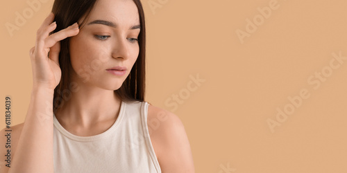 Beautiful woman on beige ba...