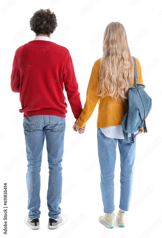 Teenage couple holding hands on white background, back view Teenage couple holding hands on white background, back view