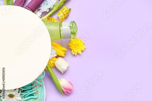 Blank card with spring flowers and sports equipment on lilac background
