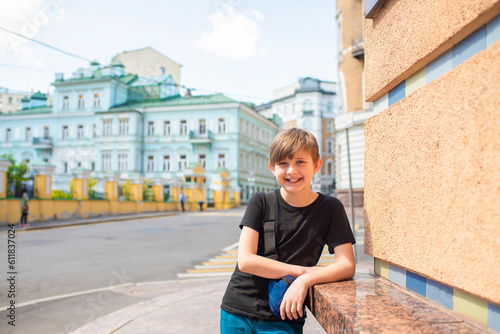 portrait of a happy boy on a sunny day in the historical center of the old European city © Ruslan Russland