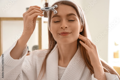 Young woman with facial mas...