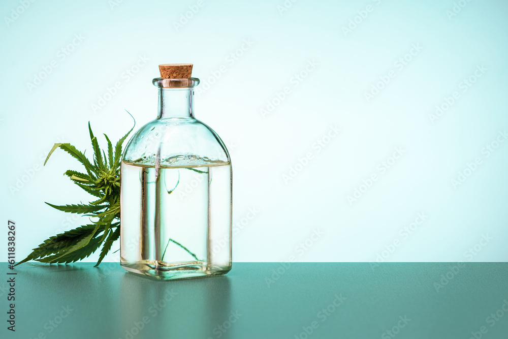 Cannabis leaves and bottle of hemp oil on the table. medical marijuana concept. Cannabis leaves and bottle of hemp oil on the table. medical marijuana concept.