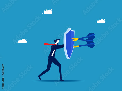 protection or security. Businessman holding shield to protect from attack