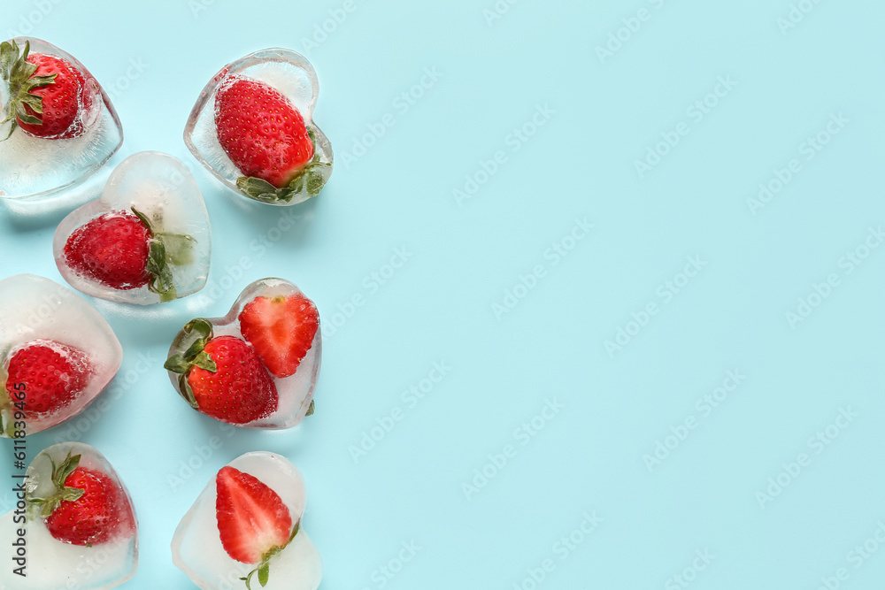 Fresh strawberry frozen in ice on blue background Fresh strawberry frozen in ice on blue background