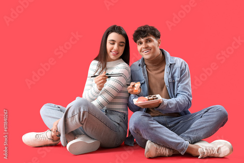 Young couple eating sushi o...