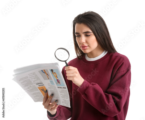 Young woman with magnifier ...