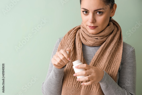 Ill young woman with pill b...