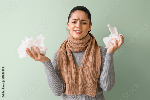Ill young woman with tissue...
