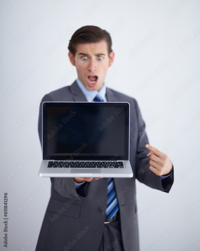Laptop screen, mockup and shocked with business man in studio for website, email and pointing. Wow, surprised and technology with employee in white background for corporate, internet and networking Laptop screen, mockup and shocked with business man in studio for website, email and pointing. Wow, surprised and technology with employee in white background for corporate, internet and networking