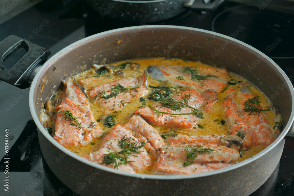 baked salmon fish in a large bowl on stove at kitchen 