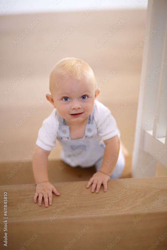 Happy, portrait of baby crawling and at his home with a smile at the stairs. Happiness or childhood development, excited or cheerful and boy child crawl at his house by the staircase smiling Happy, portrait of baby crawling and at his home with a smile at the stairs. Happiness or childhood development, excited or cheerful and boy child crawl at his house by the staircase smiling