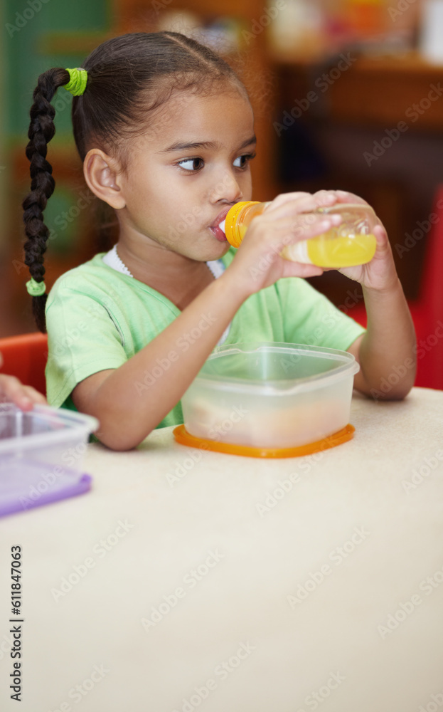 Drink, juice and girl in kindergarten with food for nutrition at school for learning in class . School, drinks and kid at table in classroom with sandwich for an education to learn at creche. Drink, juice and girl in kindergarten with food for nutrition at school for learning in class . School, drinks and kid at table in classroom with sandwich for an education to learn at creche.