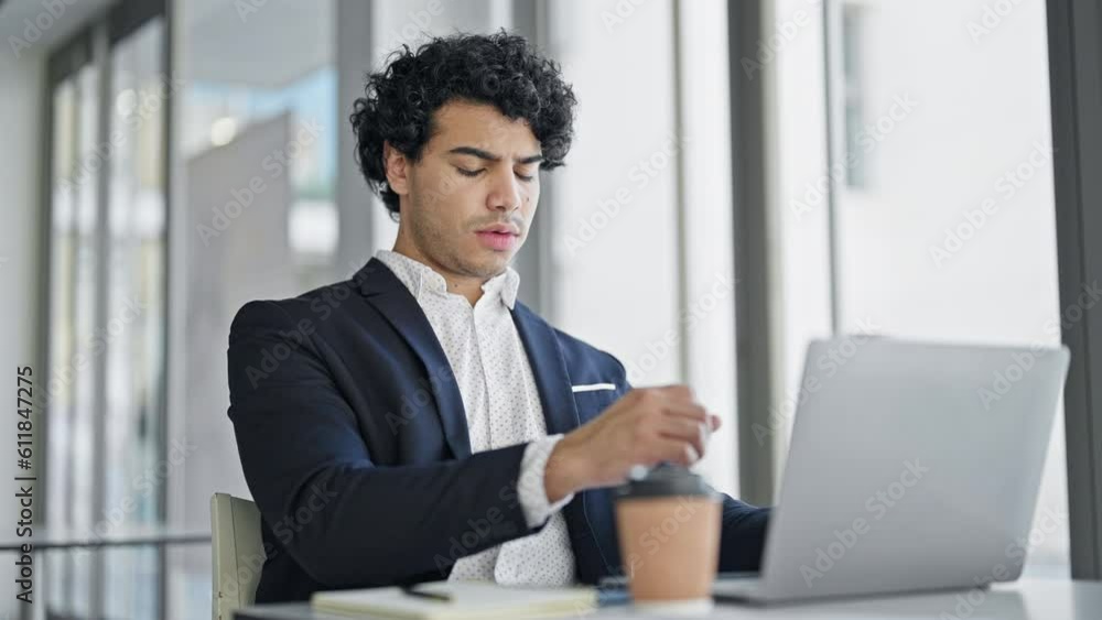 Young latin man business worker using laptop coughing at office Young latin man business worker using laptop coughing at office