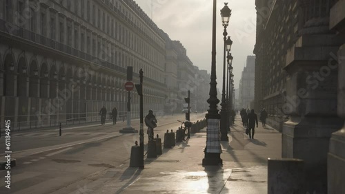 Paris, France - People Commute, Cars, Bike at Rue De Rivoli Street Morning Warm Sunrise