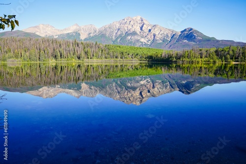 Pyramid Mountain reflected in the early morning  still  glass like waters of the stunning Patricia Lake near Jasper in the Canada rockies