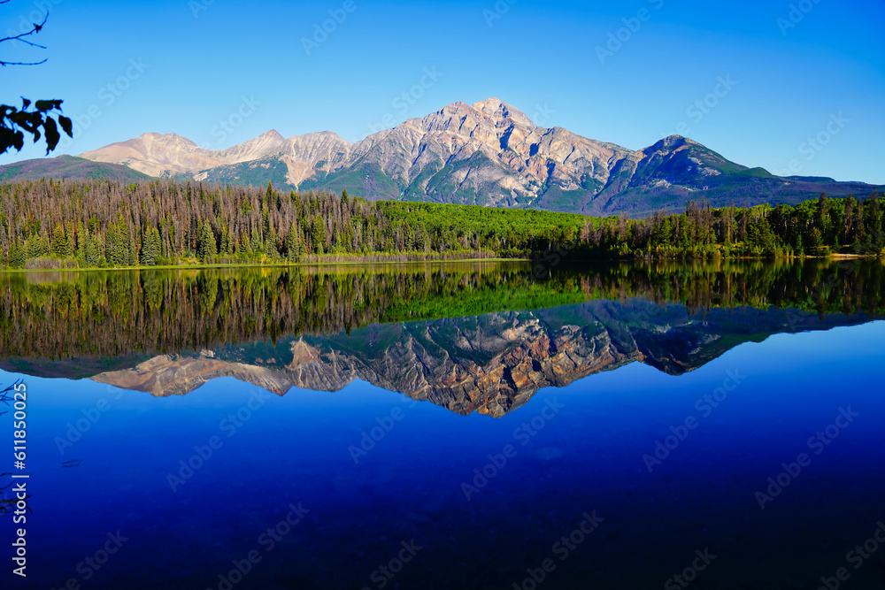 Pyramid Mountain reflected in the early morning, still, glass like waters of the stunning Patricia Lake near Jasper in the Canada rockies