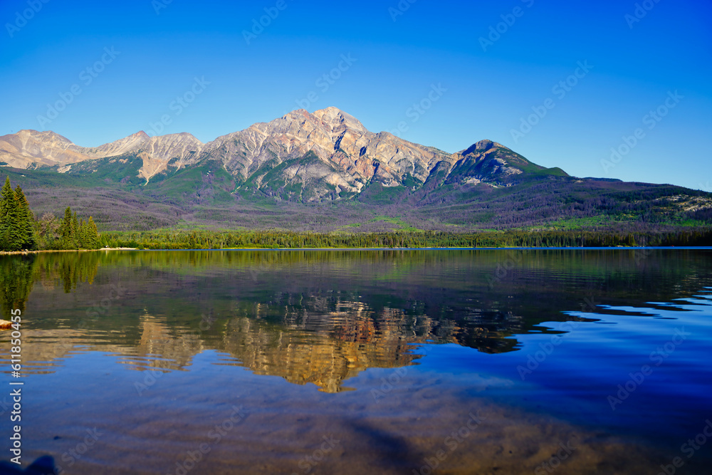 Pyramid Mountain reflected in the early morning, crystal waters of Pyramid lake near Jasper in the Canada Rockies Pyramid Mountain reflected in the early morning, crystal waters of Pyramid lake near Jasper in the Canada Rockies