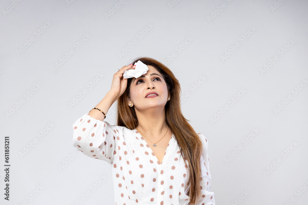 Indian woman feeling hot, using handkerchief on white background. Indian woman feeling hot, using handkerchief on white background.