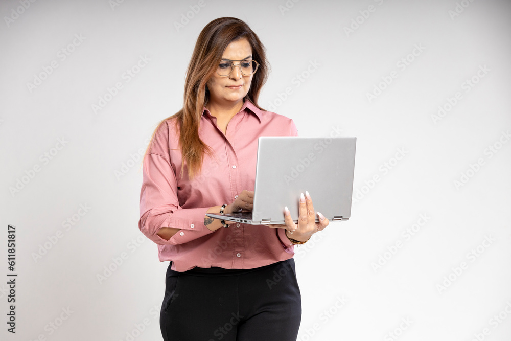 Indian businesswoman or employee using laptop on white background. Indian businesswoman or employee using laptop on white background.