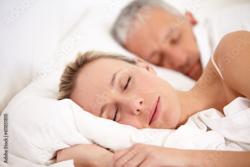 Relax, bed and a mature couple sleeping for fatigue, rest and dreaming together. Peace, house and a tired man and woman enjoying a nap, bedroom sleep or resting at night during retirement relaxation