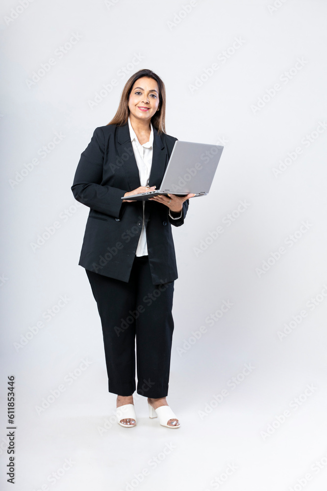 Indian businesswoman or employee using laptop on white background. Indian businesswoman or employee using laptop on white background.