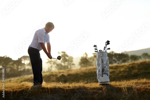 Golf, stroke and man with driver outdoor on course for training, workout or fitness at sunset mockup space. Golfing, club and person swinging for game, competition or exercise, sports and wellness.