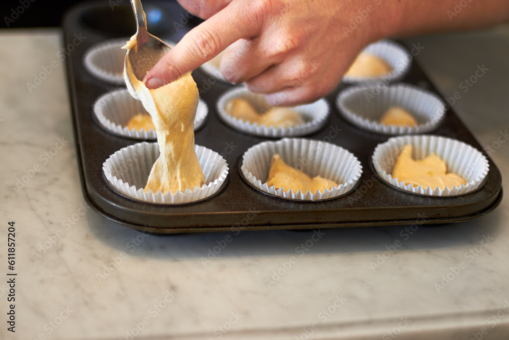 Closeup, tray and hand for cupcake dough with baker, small business owner and professional chef. Cooking, bakery and cake in baking pan for food, job or start process for muffin in restaurant kitchen Closeup, tray and hand for cupcake dough with baker, small business owner and professional chef. Cooking, bakery and cake in baking pan for food, job or start process for muffin in restaurant kitchen