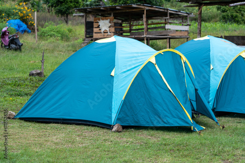 Outdoor Camping Adventure with Tent Amidst Lush Greenery © dendyh7