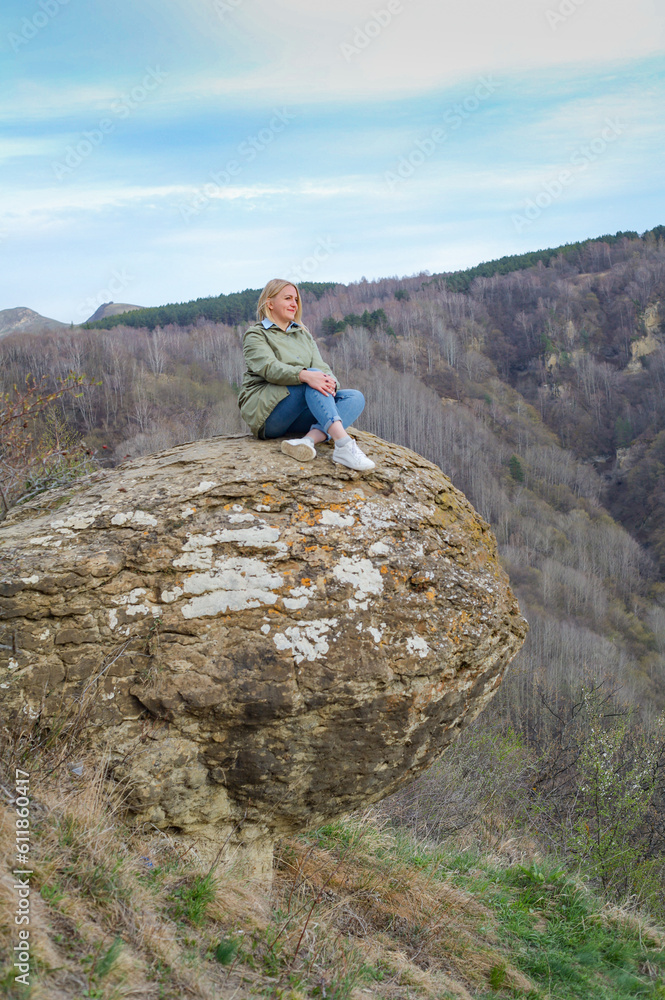 Blonde tourist enjoys vacation on mountains. Travel and relax concept Blonde tourist enjoys vacation on mountains. Travel and relax concept