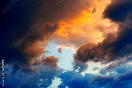 Stormy sky with clouds with blue and yellow hues and sky center