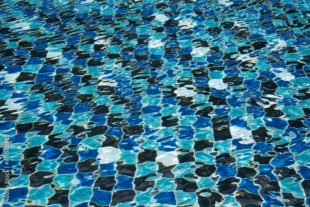 Fototapeta premium Water surface with waves on water surface wave effect You can see the blue square tiles at the bottom of the pool.