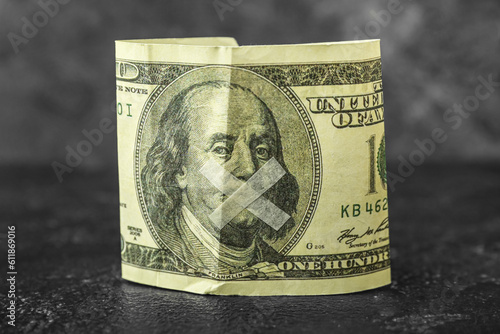 Fotografie Taped dollar banknote on dark table. Censorship concept