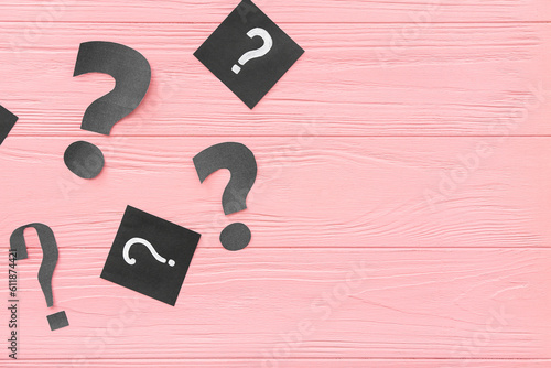 Paper question marks on pin...
