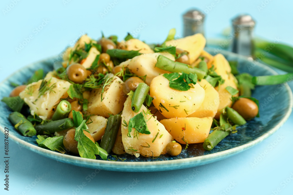 Plate of tasty Potato Salad with vegetables on blue background, closeup Plate of tasty Potato Salad with vegetables on blue background, closeup
