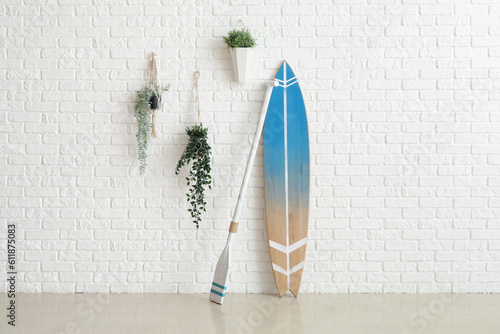 Wooden surfboard with paddl...