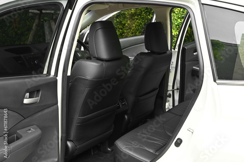 The rear passenger seat is wide and clean. Leather interior, side view, solar sunroof, buttons, Nappa leather, beige,black