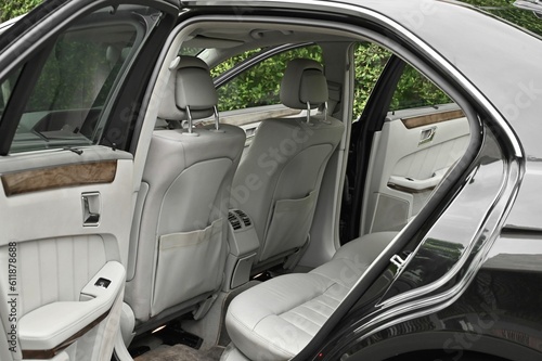 The rear passenger seat is wide and clean. Leather interior, side view, solar sunroof, buttons, Nappa leather, beige,black