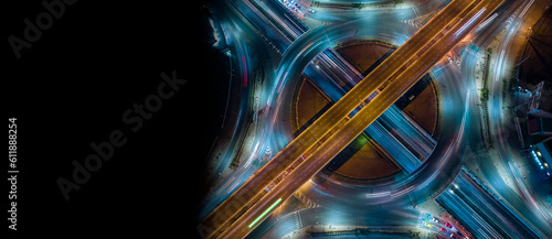 Expressway top view, Road traffic an important infrastructure, car traffic transportation above intersection road in city night, aerial view cityscape of advanced innovation, financial technology 