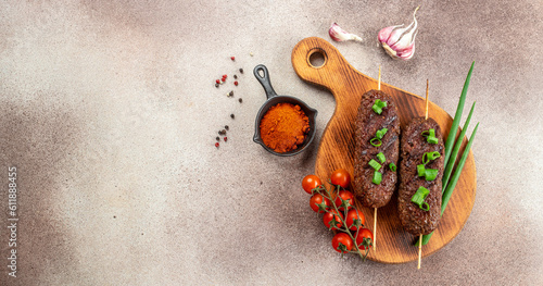 lyulya kebab minced meat, shish kebab grilled on a light background, Long banner format. top view photo