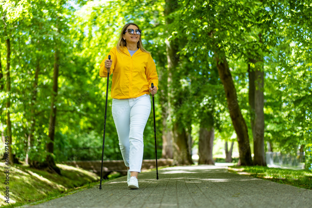 Nordic walking - woman training in city park
Nordic walking - woman training in city park