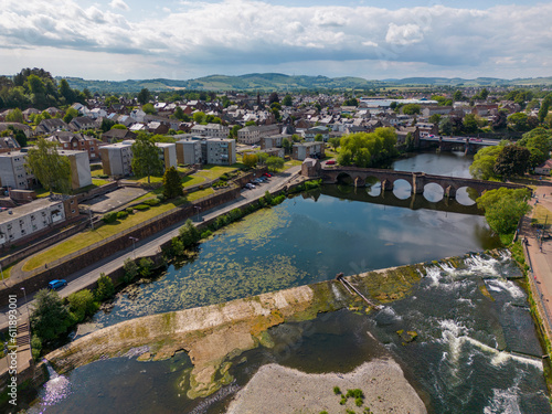 This aerial drone photo shows the town of Dumfries in the district of Dumfries and Galloway in Scotland. You can see the river Nith which flows through the center of the town. 