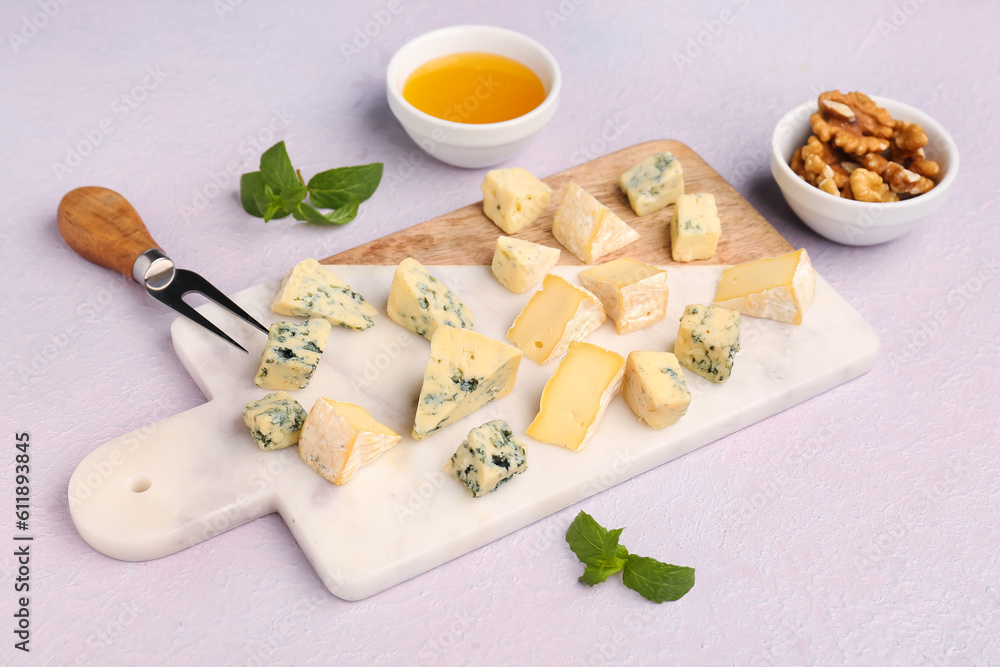 Board with pieces of tasty cheese on light background Board with pieces of tasty cheese on light background