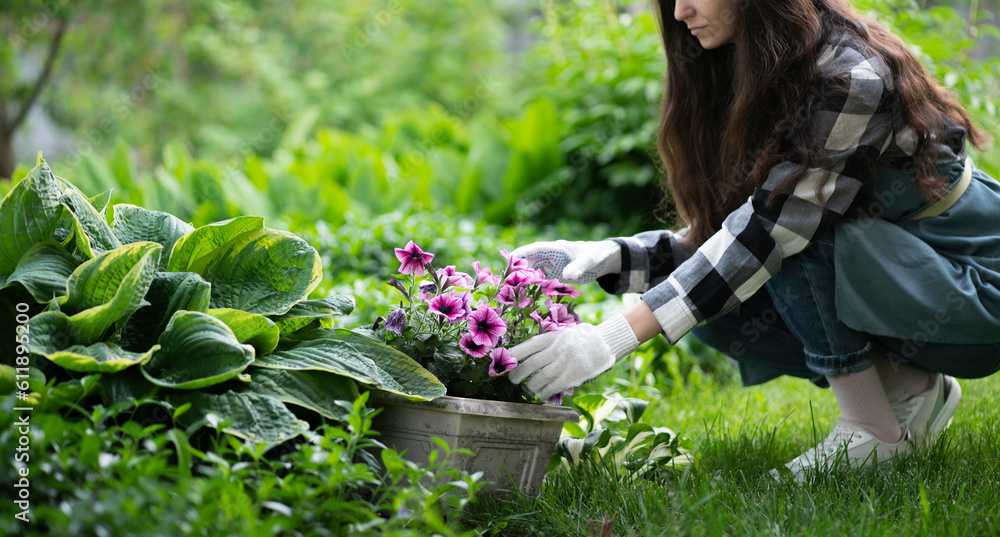 young female florist growing some flowers in the garden