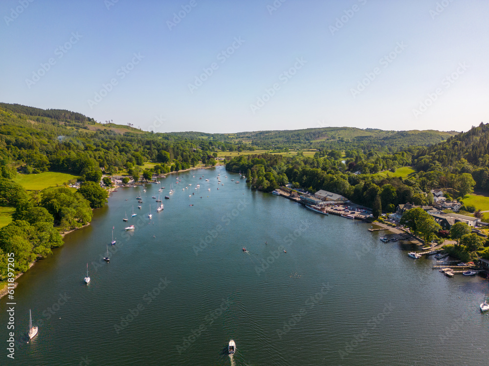 This aerial drone photo shows Lake Windermere which is the largest lake in the Lake District. This beautiful nature can be found in Cumbria, North-West England. It's summer and there are many boats. 