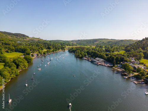 This aerial drone photo shows Lake Windermere which is the largest lake in the Lake District. This beautiful nature can be found in Cumbria, North-West England. It's summer and there are many boats. 