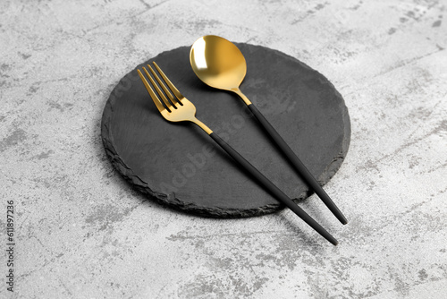 Photography Board with golden spoon and fork on grey background