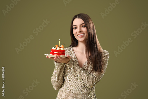 Beautiful young woman with sweet birthday cake on color background