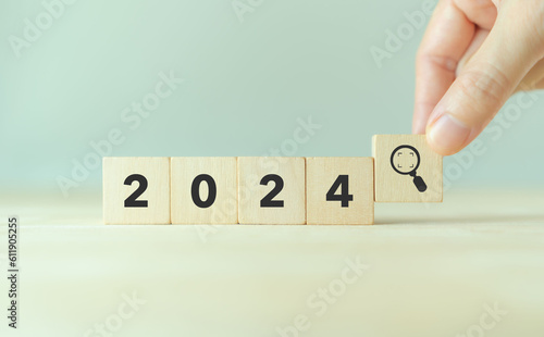 2024 trend and seeking new opportunities concept. Wooden cube with 2024, magnifying glass icon. Used for banner in trend concept in new year for monitoring new opportunities, process improvement.